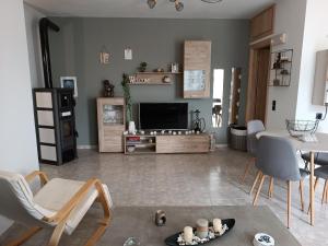 a living room with a television and a table and chairs at Thea Home Rhodes Pastida in Pastida