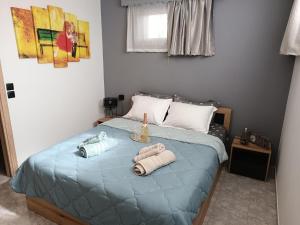a bedroom with a bed with towels on it at Thea Home Rhodes Pastida in Pastida