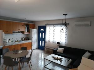 a living room and kitchen with a couch and a table at Thea Home Rhodes Pastida in Pastida +13 photos