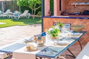 a blue table with plates and glasses on a patio at Casa Rural Carmo in Carmona