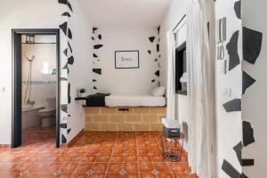 a bathroom with a bed on a wall with black butterflies at Apartamento La Listada Alto in La Listada +29 photos