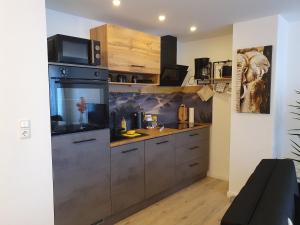 a kitchen with a large stainless steel refrigerator at Hochwertige Ferienwohnung in Lübeck