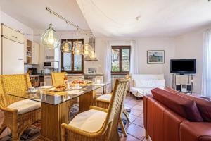a kitchen and living room with a table and chairs at Appartment Capri in Tignale