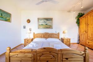 a bedroom with a large wooden bed and two night stands at Appartment Capri in Tignale