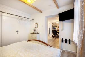 a bedroom with a bed and a view of a living room at Hochwertige Ferienwohnung in Lübeck