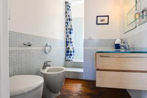 a bathroom with a sink and a toilet and a tub at Loft il Mare Rio Marina front sea in Rio Marina +29 photos