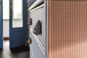 a butterfly is sitting on the side of a door at Loft il Mare Rio Marina front sea in Rio Marina