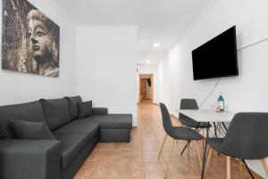 a living room with a couch and a table at One life one dream Gran Canaria in Carrizal