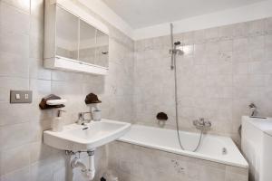a bathroom with a sink and a bath tub at Maison Tillier Valtournenche in Valtournenche