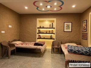 a hospital room with two beds and a chandelier at Pindari Homestay in Bāgeshwar