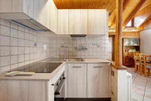 a kitchen with white cabinets and a sink at Maison Tillier Valtournenche in Valtournenche +18 photos
