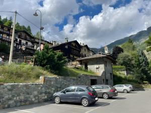 a group of cars parked in a parking lot at Maison Tillier Valtournenche in Valtournenche