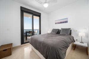 a bedroom with a large bed and a large window at Roya Vistamar in Torrox Costa +20 photos