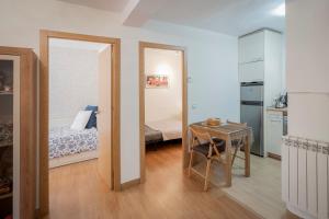 a bedroom with a bed and a table in a room at Rodrigo in Palencia
