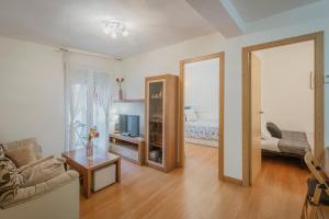 a living room with a couch and a mirror at Rodrigo in Palencia