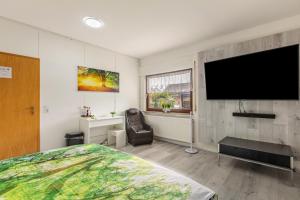 a bedroom with a large flat screen tv on the wall at Haus Sonnenschein Bad Säckingen in Bad Säckingen