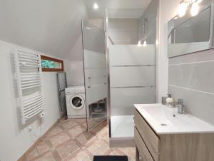a bathroom with a sink and a washing machine at Gîte Le Clos aux Cerises in Eu +11 photos