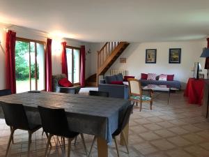a living room with a table and chairs at Gîte Le Clos aux Cerises in Eu
