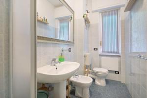 a white bathroom with a sink and a toilet at Casa Nio in Rapallo +27 photos