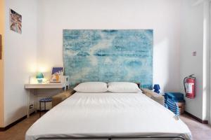 a bedroom with a large white bed in it at Casa Nio in Rapallo