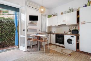 a kitchen with a table and a washing machine at Casa Nio in Rapallo