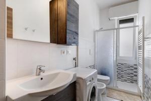 a white bathroom with a sink and a toilet at Loano Home in Loano +12 photos