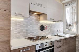 a kitchen with a sink and a stove at Loano Home in Loano