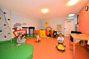 a group of children playing in a play room at Alpenchalet Niederkofler Isabella in San Giovanni in Val Aurina +10 photos