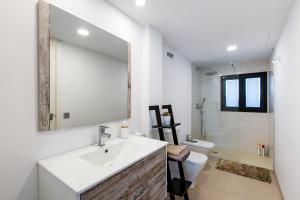 a bathroom with a sink and a toilet and a mirror at Beach Pearl Cala de Mijas in Mijas +17 photos