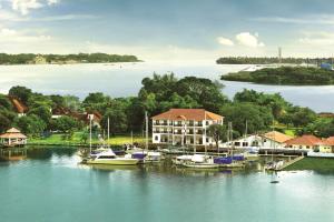 a group of boats docked in a marina on a lake at Bolgatty Palace & Island Resort in Cochin