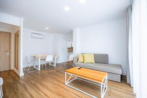 a living room with a couch and a table at Apartament Massanet 1b in Canyamel