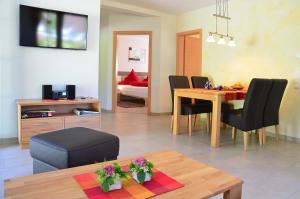 a living room with a table and chairs and a dining room at Zipperhof in Lahr