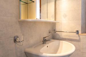 a bathroom with a sink and a mirror at Casa Isidora in Acquaviva +16 photos
