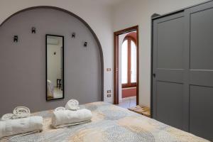 a bedroom with a bed with two towels on it at Casa Isidora in Acquaviva