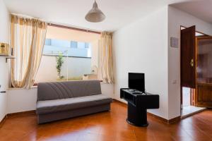 a living room with a couch and a piano at Casa Fortuna in Gallipoli