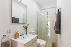 a bathroom with a white sink and a shower at Maca Sol in Campanet +12 photos