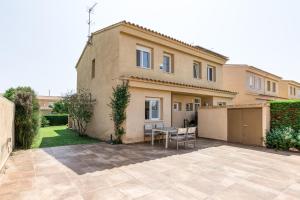 a house with a patio in front of it at Pinamar casa con piscina in L'Escala