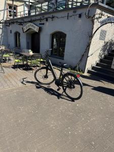a bike parked in front of a building at Hotel Haus Burg Metternich in Beilstein