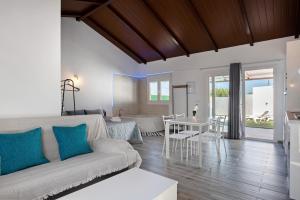 a living room with a couch and a table at La Teja 3 - Solo Familias in Vejer de la Frontera