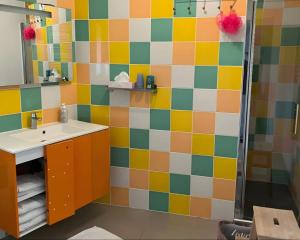 a bathroom with a sink and a shower at Gite L'atelier De Théophile in Peltre +9 photos