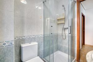 a bathroom with a glass shower and a toilet at Paseo el Saladar in Denia +17 photos