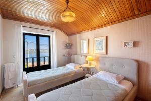 a room with two beds and a window at Casa Do Bico Da Biarritz in Costa Nova +31 photos