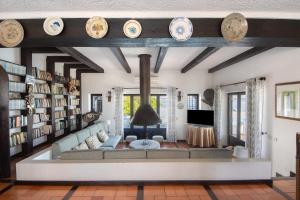 a living room with a couch and bookshelves at Casa Do Bico Da Biarritz in Costa Nova