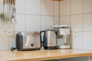 a kitchen counter with a coffee maker and a toaster at Appart Cancale Centre-ville - Mer in Cancale