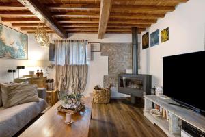 a living room with a couch and a flat screen tv at Casa Collicello relax in Camaiore