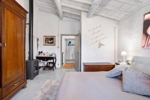 a white bedroom with a bed and a desk at Casa Collicello relax in Camaiore +37 photos