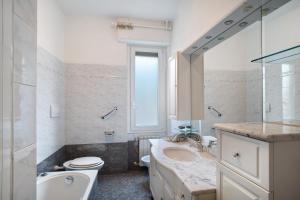 a bathroom with a sink and a toilet and a tub at Alassio Holiday in Alassio +18 photos