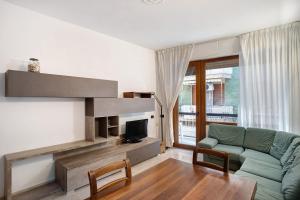 a living room with a couch and a tv at Alassio Holiday in Alassio