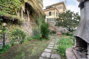 a stone wall with a walkway in front of a building at Alassio Holiday in Alassio