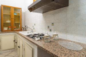 a kitchen with a stove and a sink at Ciuri Ciuri in Avola +18 photos